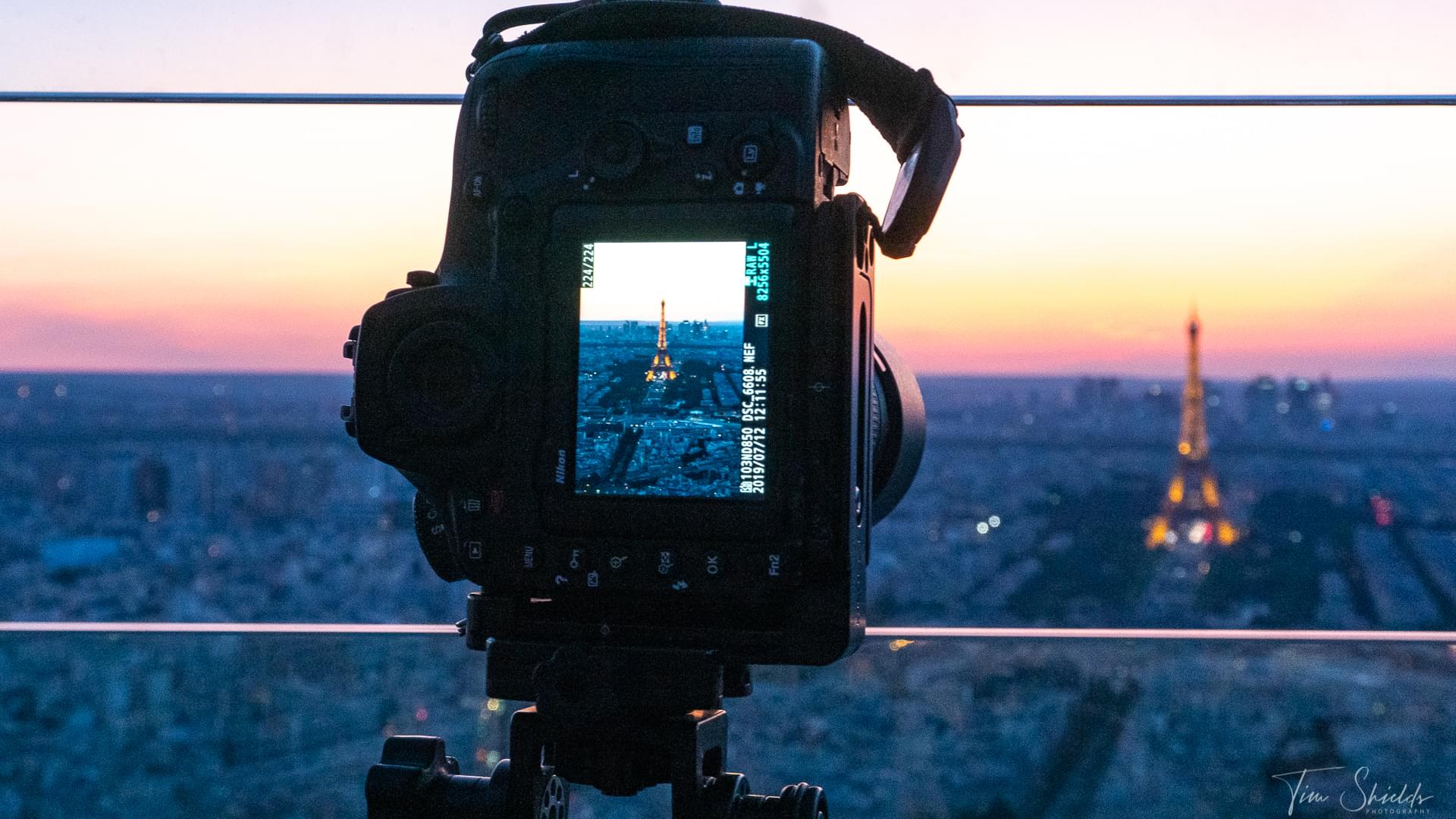 camera on a tripod on the roof of the tallest building in Paris